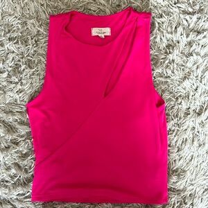 Fitted pink, cropped tank top- it has a slit on the left side as seen above.